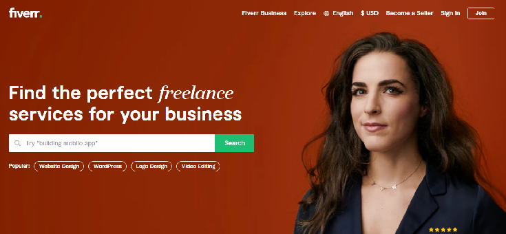 A screenshot of Fiverr's homepage. It has a red background. There's a smirking woman with tousled shoulder length hair, a side part, and a navy blue blazer. The post is about How to Hire Your First Freelancer on Fiverr. 
