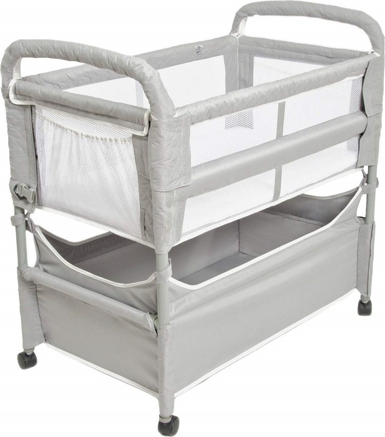 The Arm's Reach Clear Vue Co-Sleeper Bassinet. It has 4 castor wheels, a large bottom storage bin, and an upper bassinet area with mesh sides. In Review. 